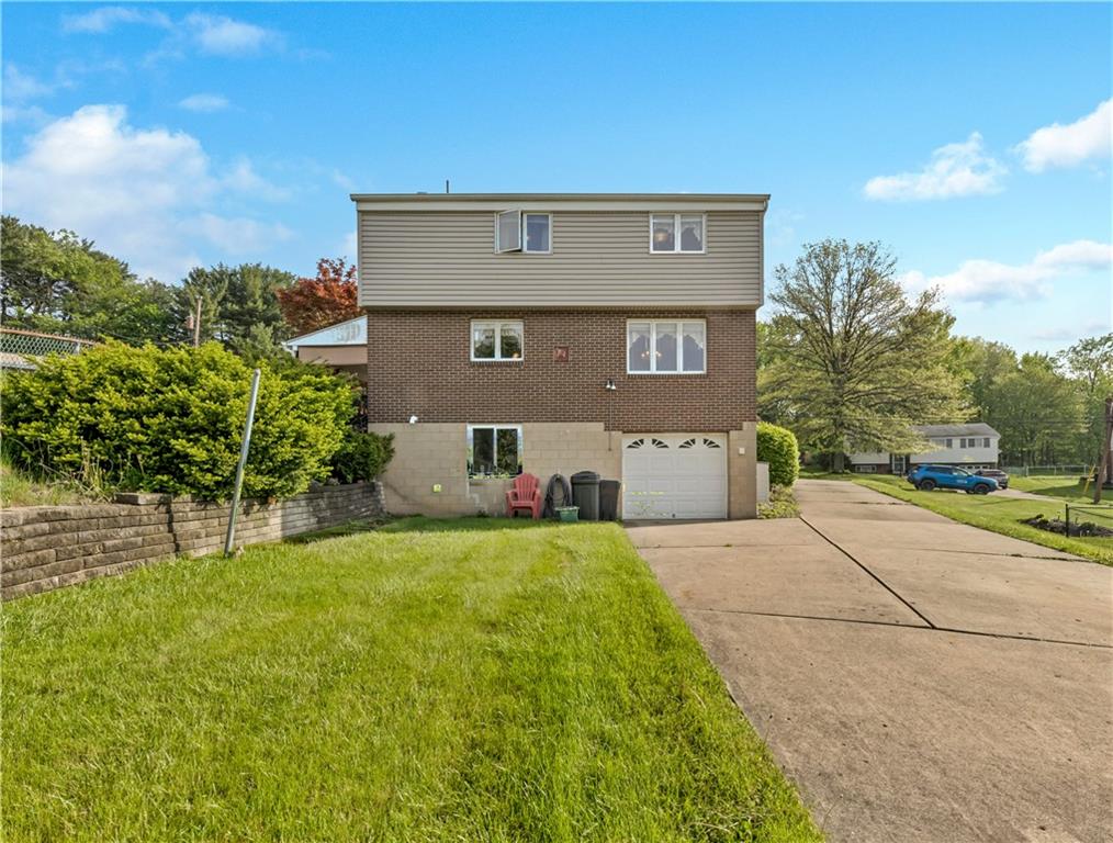 1004 Fiddleback Drive McKees Rocks, PA 15136 - Photo 25 of 25 a front view of a house with a yard and garage
