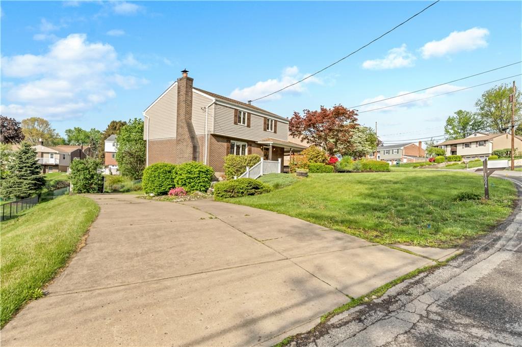 1004 Fiddleback Drive McKees Rocks, PA 15136 - Photo 3 of 25 a view of a garden with a building in the background