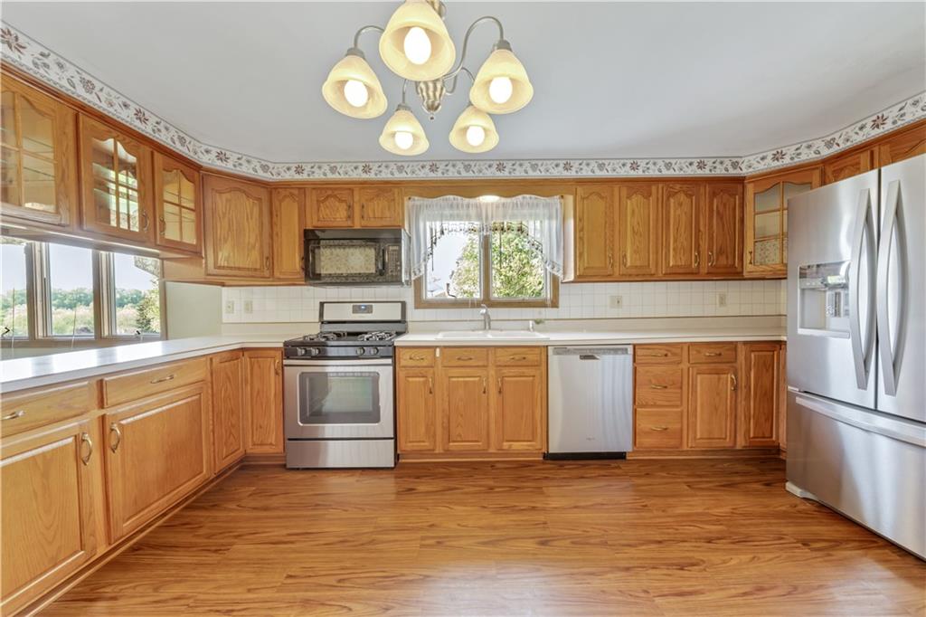 1004 Fiddleback Drive McKees Rocks, PA 15136 - Photo 7 of 25 a kitchen with stainless steel appliances granite countertop a stove and a refrigerator