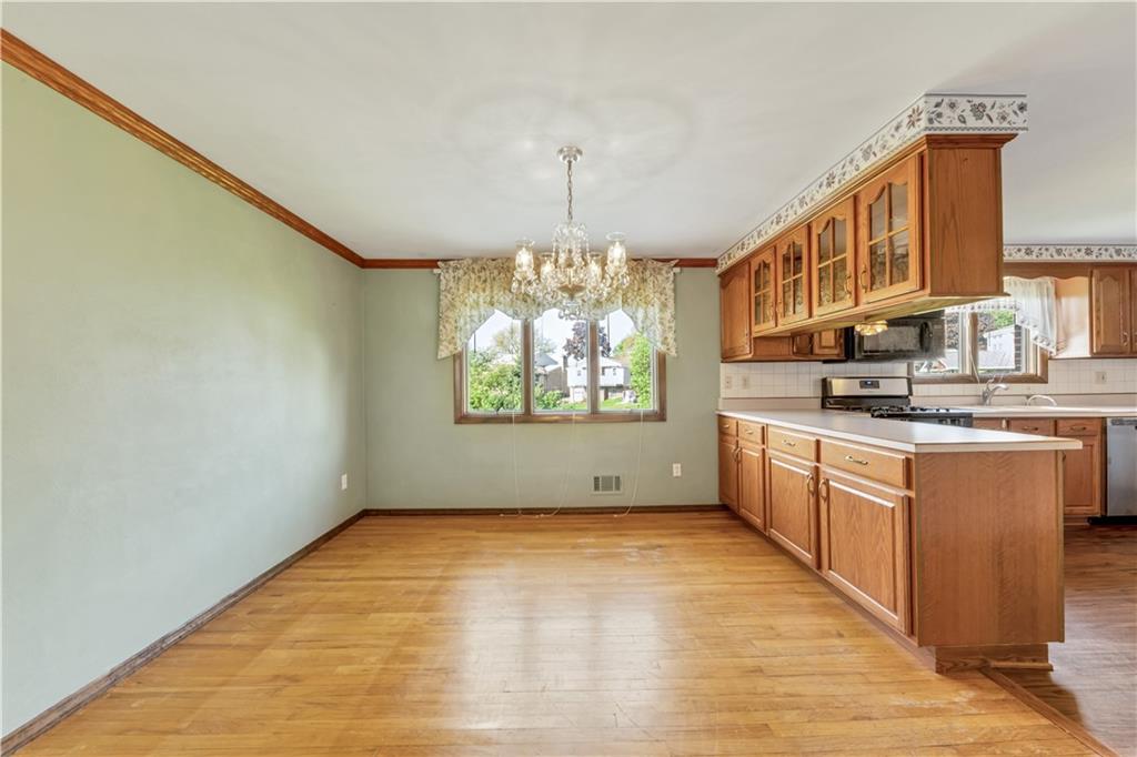 1004 Fiddleback Drive McKees Rocks, PA 15136 - Photo 10 of 25 a kitchen with stainless steel appliances granite countertop a stove a sink dishwasher and a refrigerator