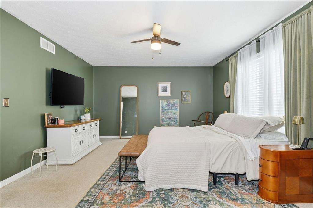 4766 McKee Court Southwest Mableton, GA 30126 - Photo 19 of 33 a spacious bedroom with a bed and a flat screen tv