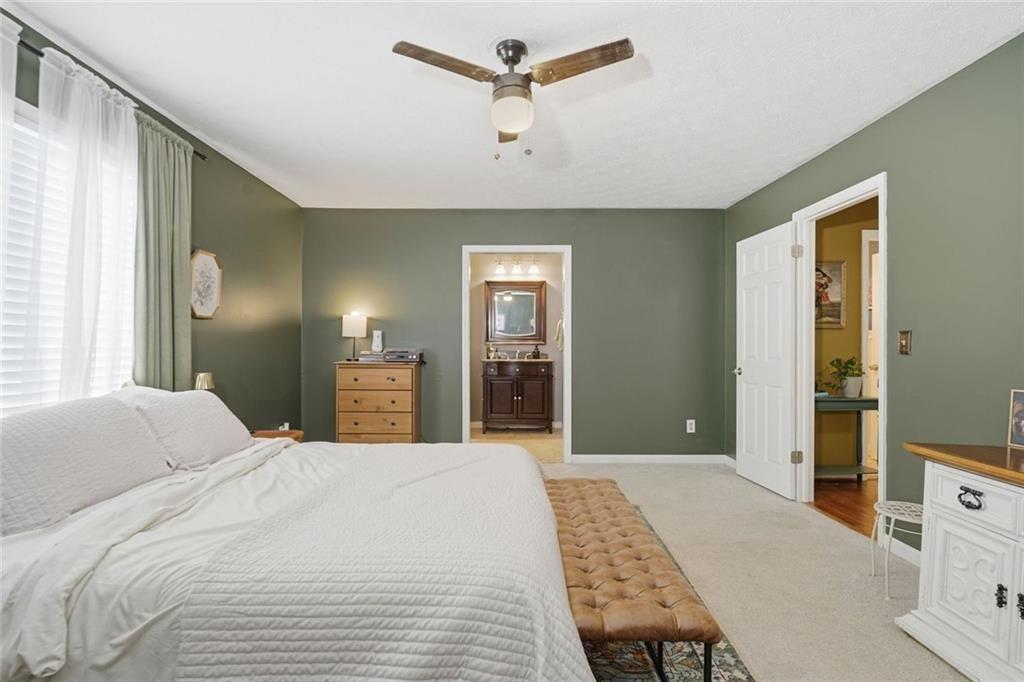 4766 McKee Court Southwest Mableton, GA 30126 - Photo 21 of 33 a bedroom with a large bed and a chandelier