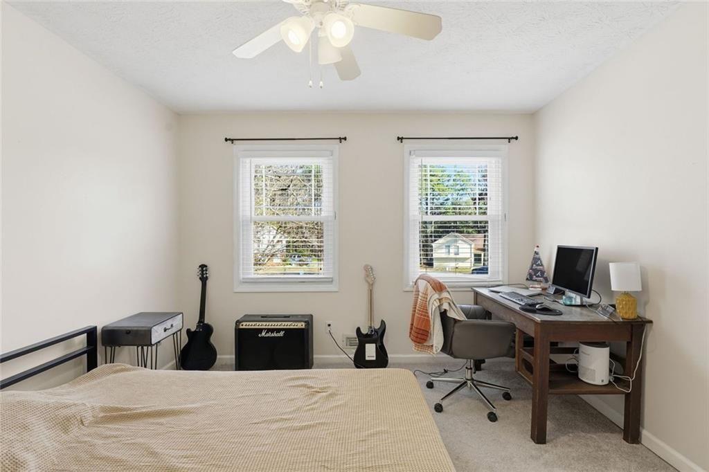 4766 McKee Court Southwest Mableton, GA 30126 - Photo 23 of 33 a bedroom with a bed large window and a desk