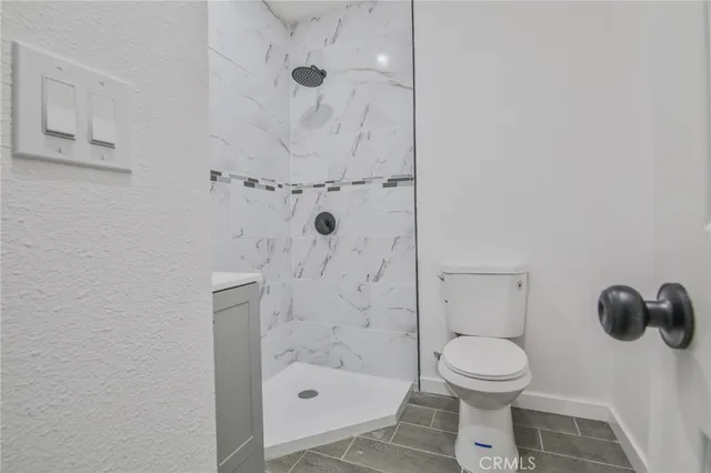 a bathroom with a toilet and a shower