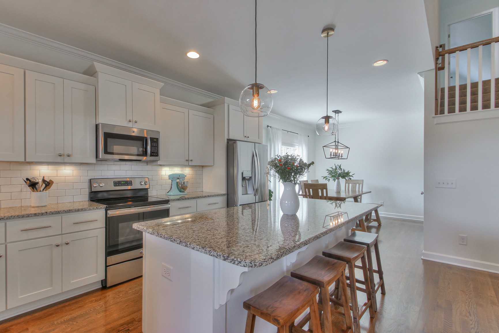 6032 Sanmar Drive Spring Hill, TN 37174 - Photo 13 of 29 a kitchen with stainless steel appliances granite countertop a kitchen island hardwood floor sink and stove
