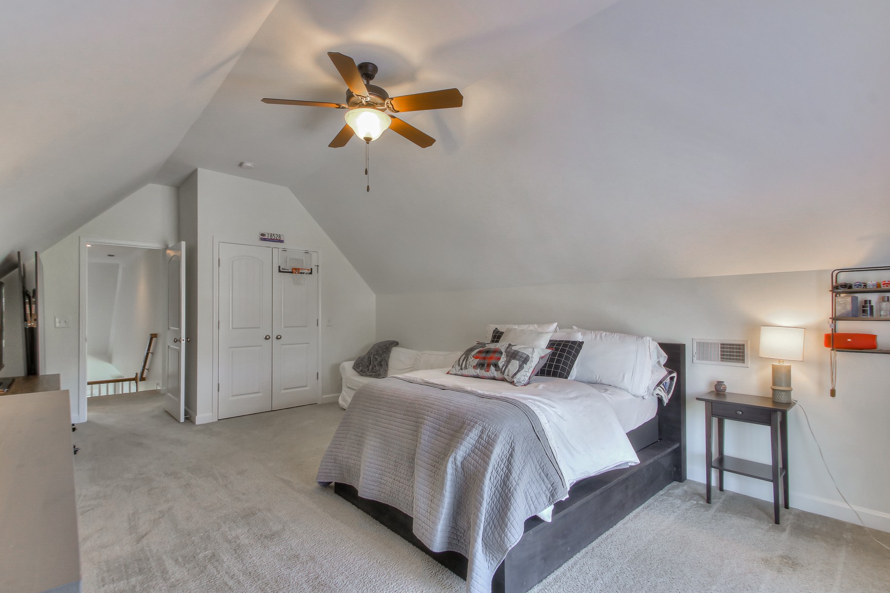 6032 Sanmar Drive Spring Hill, TN 37174 - Photo 26 of 29 a bedroom with a bed and a chandelier