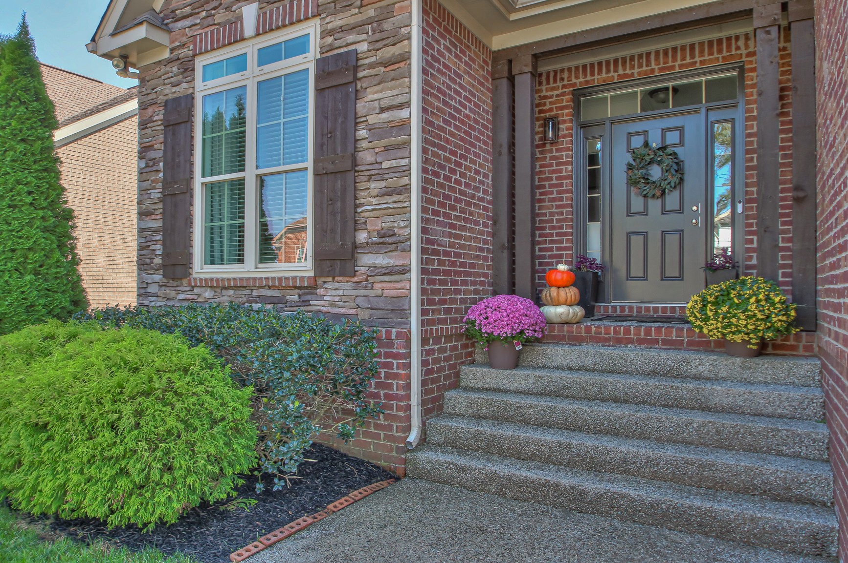 6032 Sanmar Drive Spring Hill, TN 37174 - Photo 3 of 29 a view of a brick house with potted plants