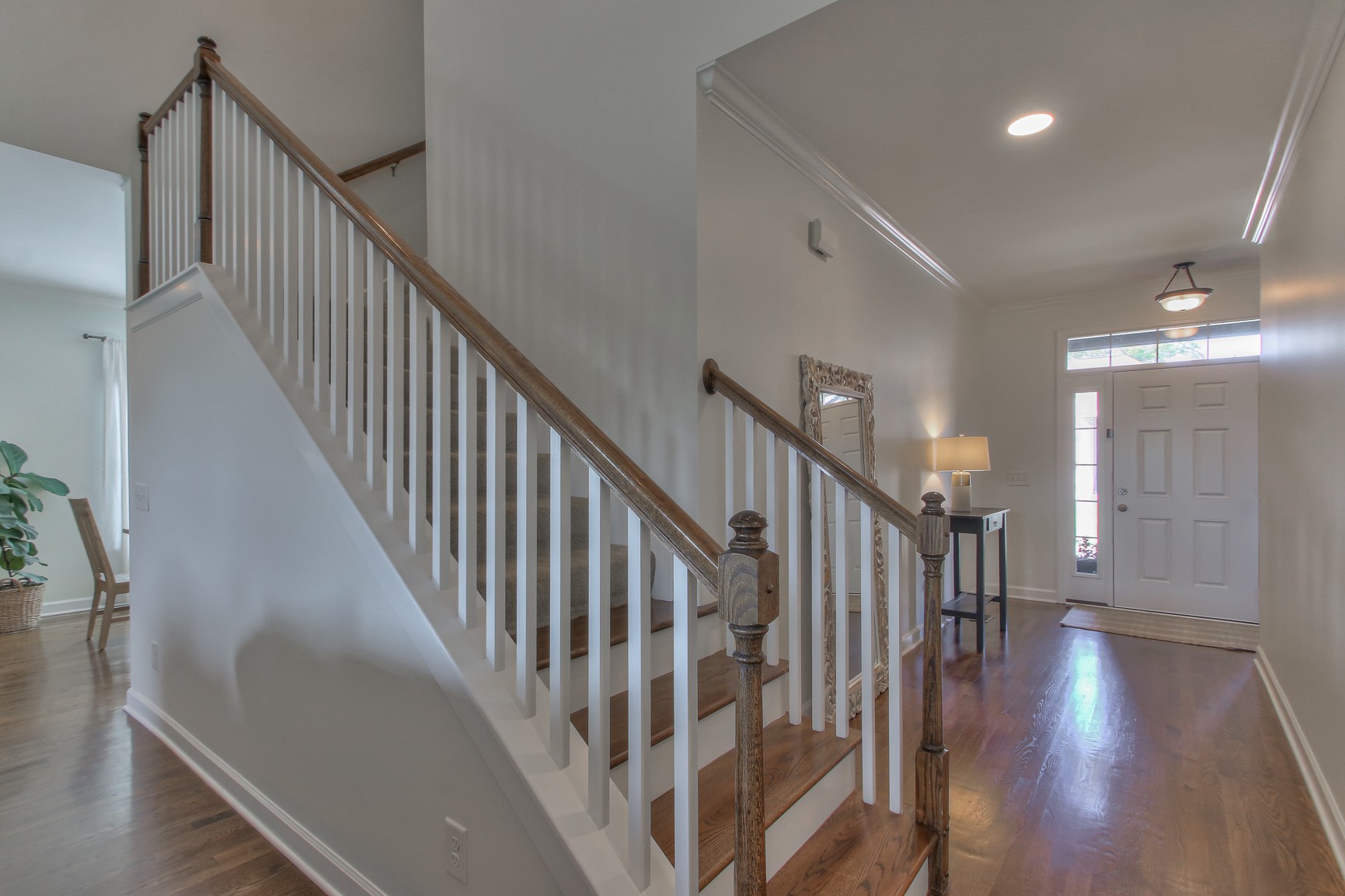 6032 Sanmar Drive Spring Hill, TN 37174 - Photo 4 of 29 a view of staircase with lots of frames on wall and wooden floor