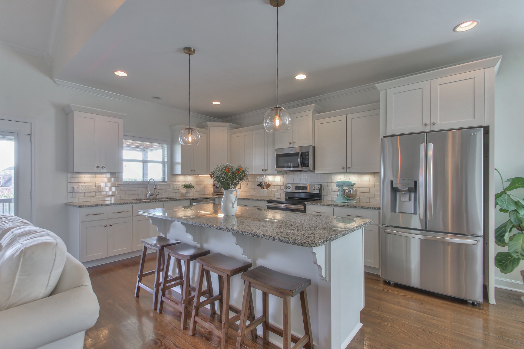 6032 Sanmar Drive Spring Hill, TN 37174 - Photo 8 of 29 a kitchen with stainless steel appliances granite countertop a refrigerator a sink a stove a dining table and chairs