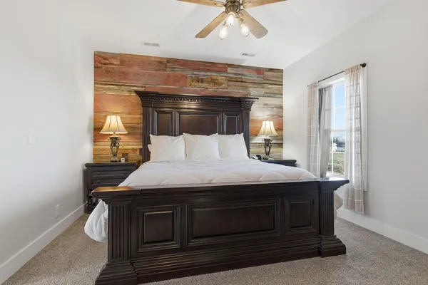 a dining hall with stainless steel appliances granite countertop a stove and a view of living room
