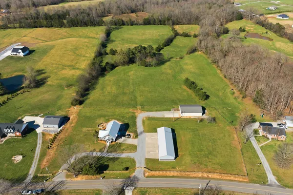 an aerial view of a house with a yard
