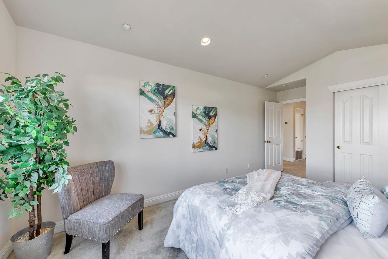 751 Pecan Way Campbell, CA 95008 - Photo 24 of 36 a bedroom with a bed and a chair with potted plant