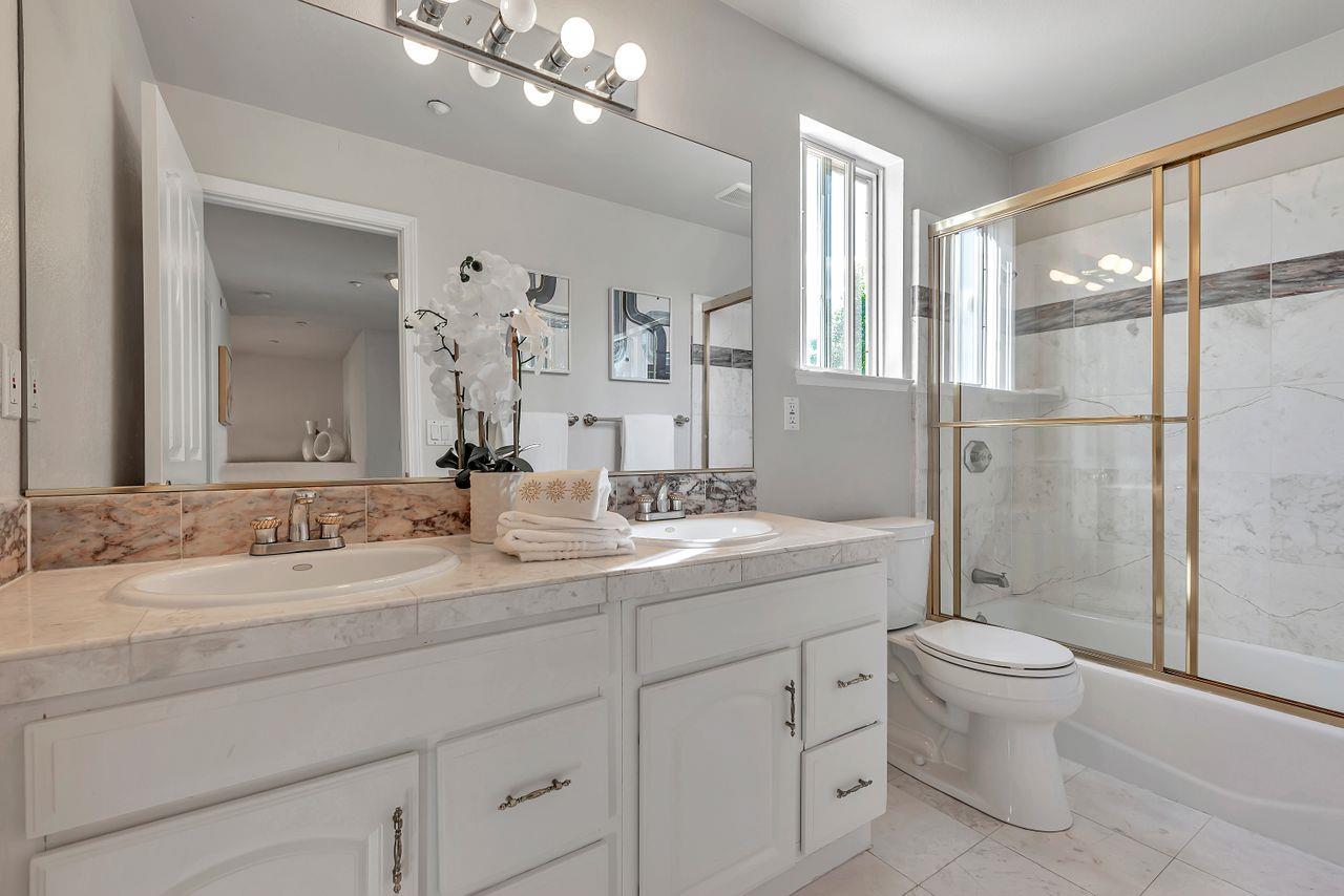 751 Pecan Way Campbell, CA 95008 - Photo 28 of 36 a bathroom with a double vanity sink toilet mirror and shower