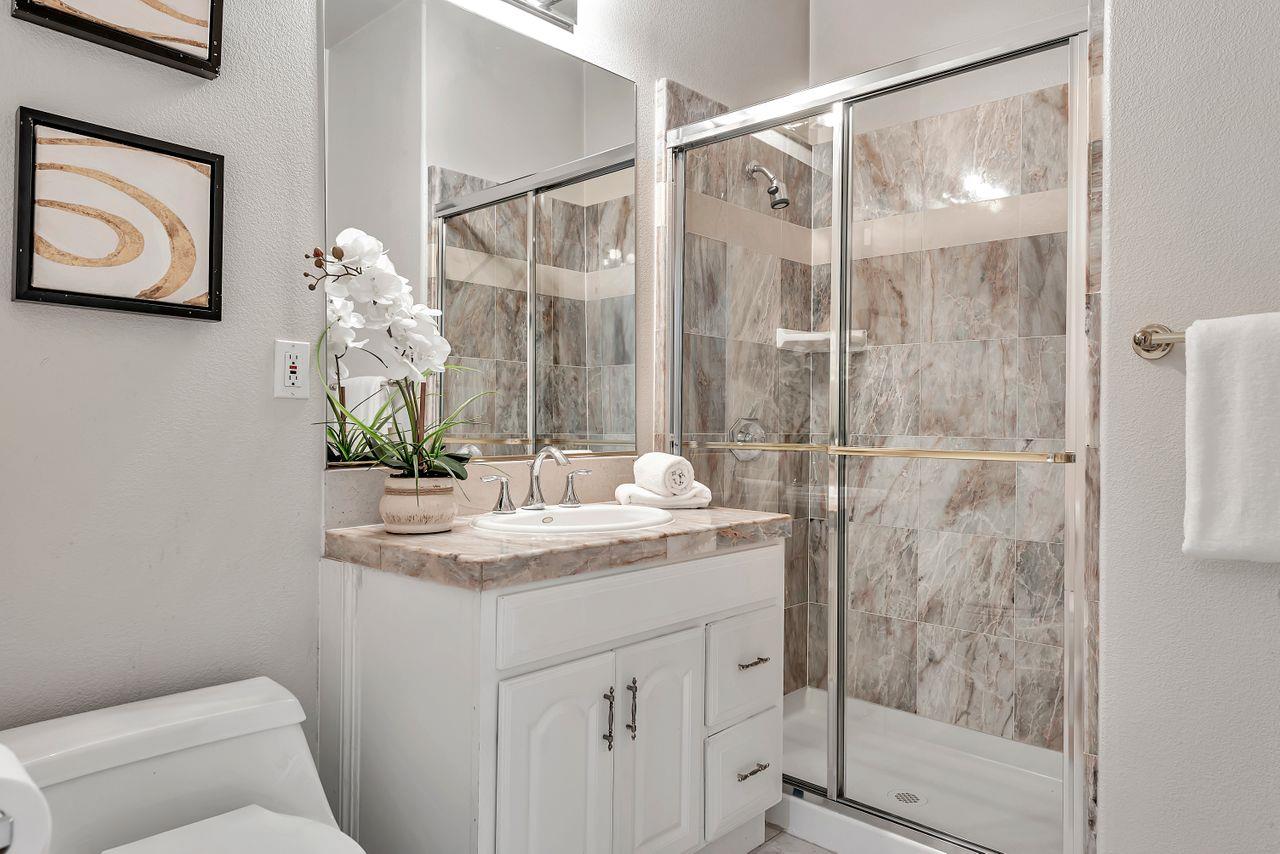 751 Pecan Way Campbell, CA 95008 - Photo 30 of 36 a bathroom with a granite countertop sink a toilet and shower