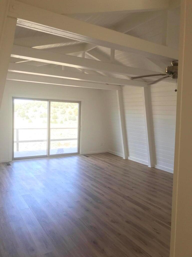 523-400 South Grasshopper Road Termo, CA 96132 - Photo 24 of 44 a view of empty room with wooden floor and fan