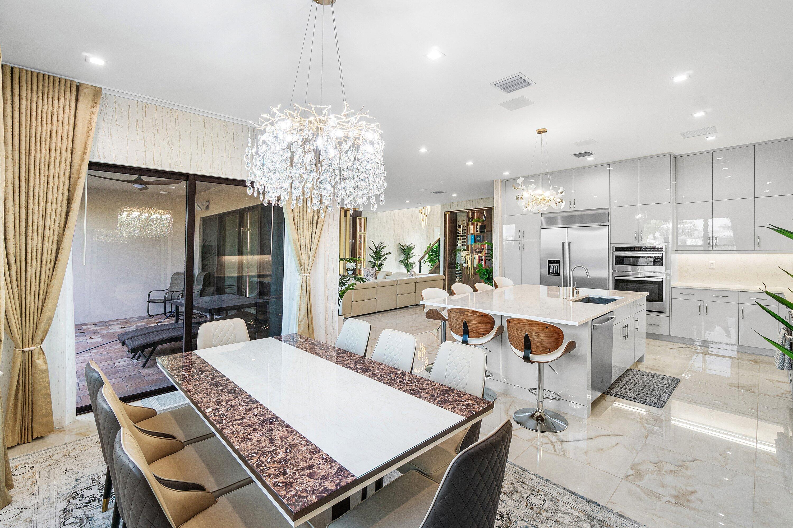 8233 Crystal Downs Avenue Boca Raton, FL 33434 - Photo 19 of 58 a large kitchen with a table and chairs