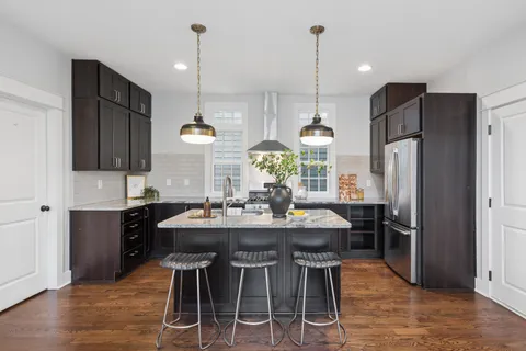 a kitchen with refrigerator cabinets dining table and chairs