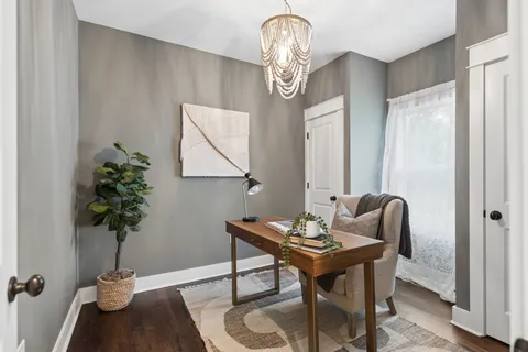 a living room with furniture and a potted plant