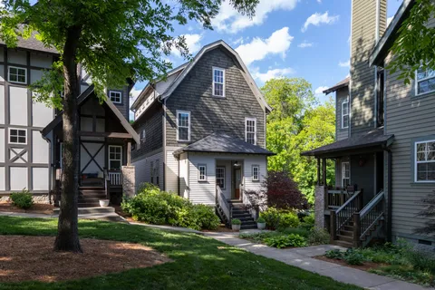 a front view of a house with a garden