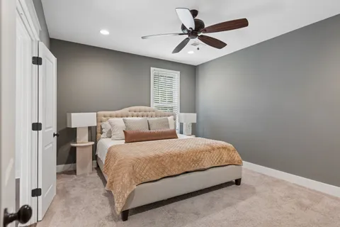 a bedroom with a bed and a ceiling fan
