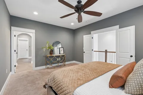 a bedroom with a bed and a chandelier