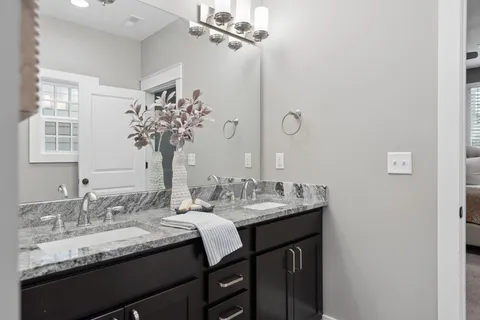 a dining room with granite countertop a sink and a mirror
