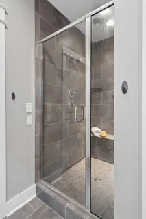 a bathroom with a glass shower door