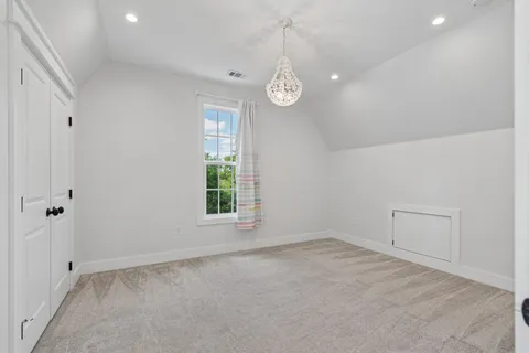 an empty room with windows and closet