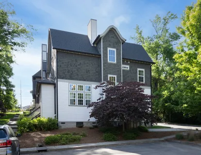 a view of a house with a yard and plants