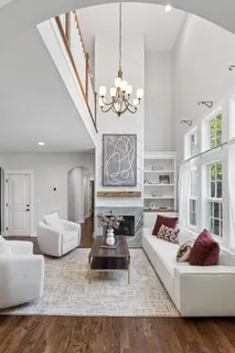 a living room with furniture and a chandelier