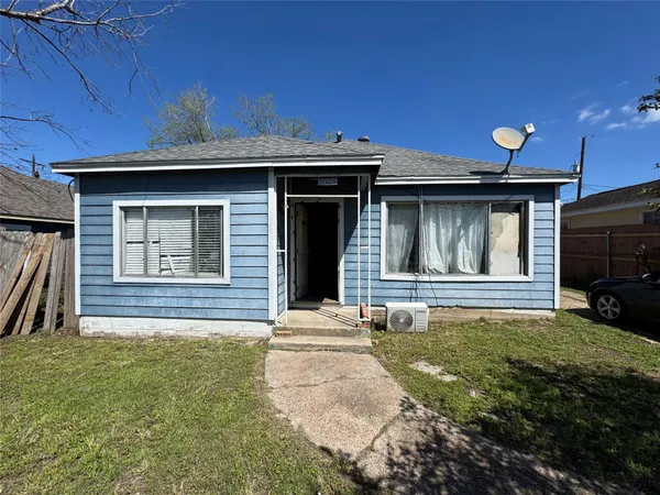 a view of a hallway with couch and chandelier