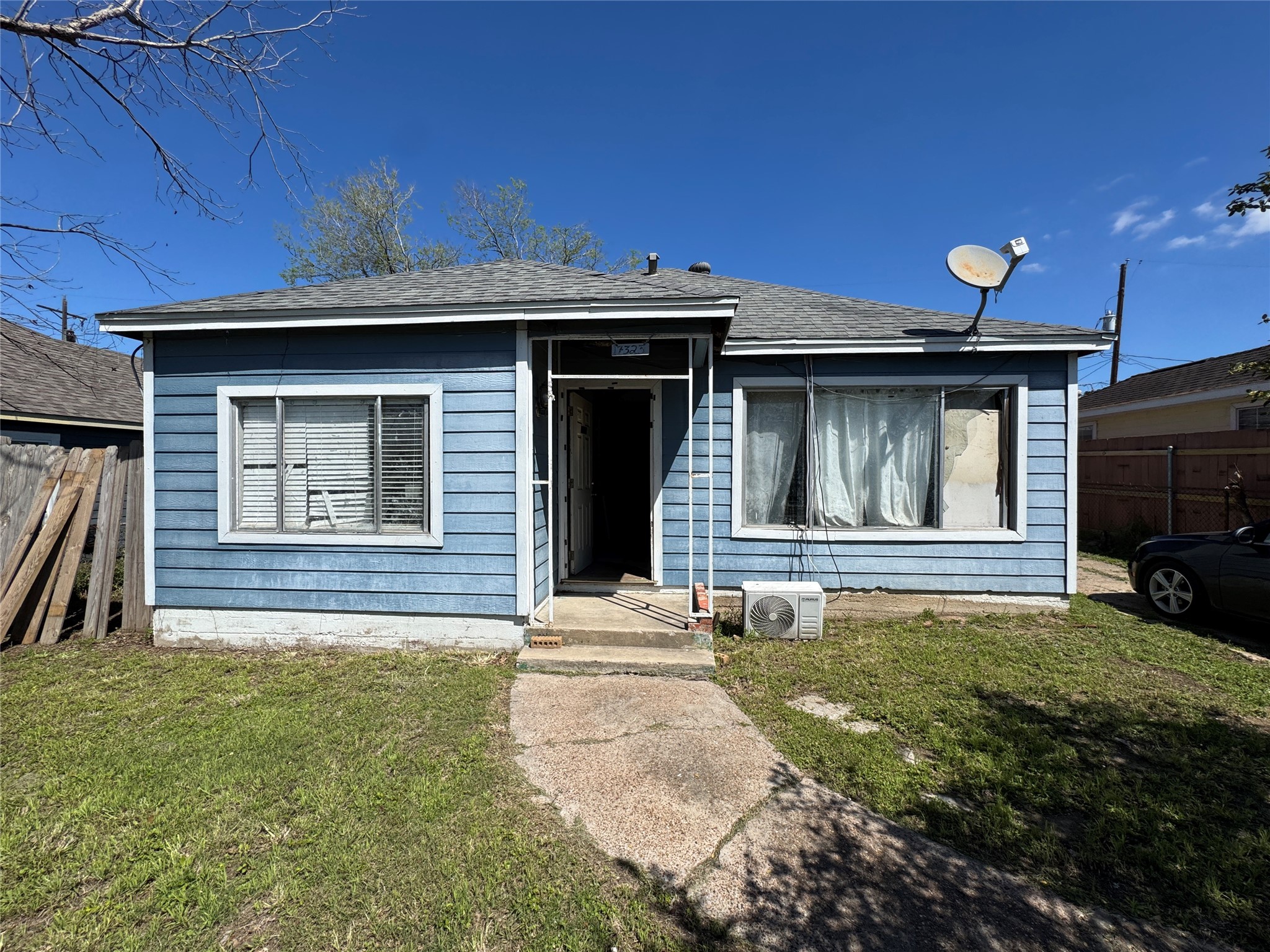 7323 Dallas Street Houston, TX 77011 - Photo 2 of 8 a front view of a house with a yard