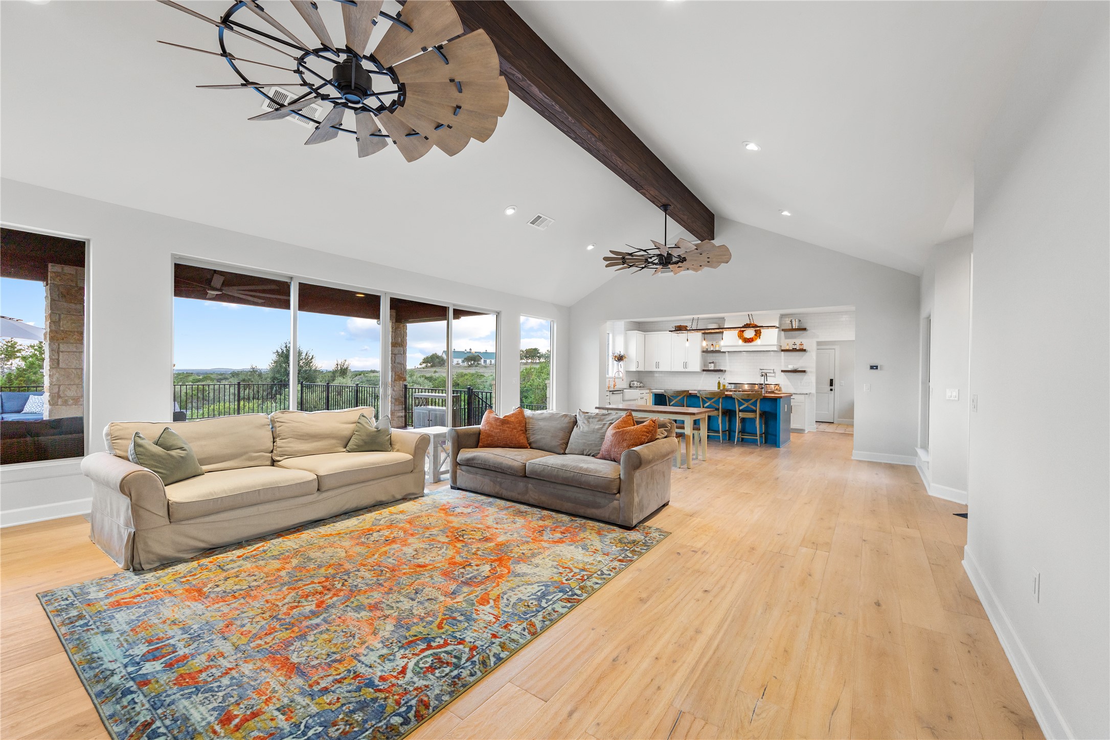 1017 Westland Ridge Road Dripping Springs, TX 78620 - Photo 8 of 40 High vaulted ceilings and wood beams crown this spacious open-concept living area.