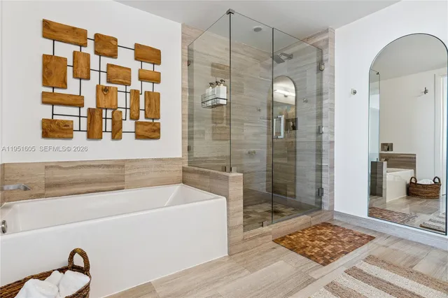 a bathroom with a bathtub and a shower