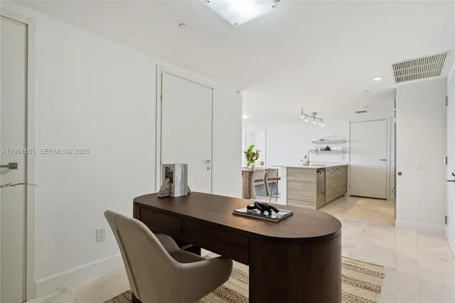 a dining room with a table and chairs