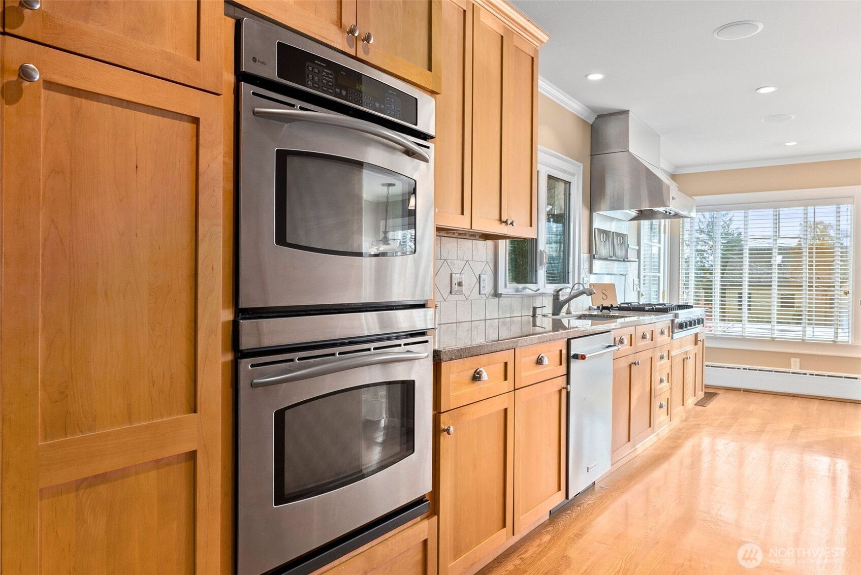 317 West 10th Street Aberdeen, WA 98520 - Photo 13 of 40 a kitchen with stainless steel appliances granite countertop a stove a sink and a refrigerator
