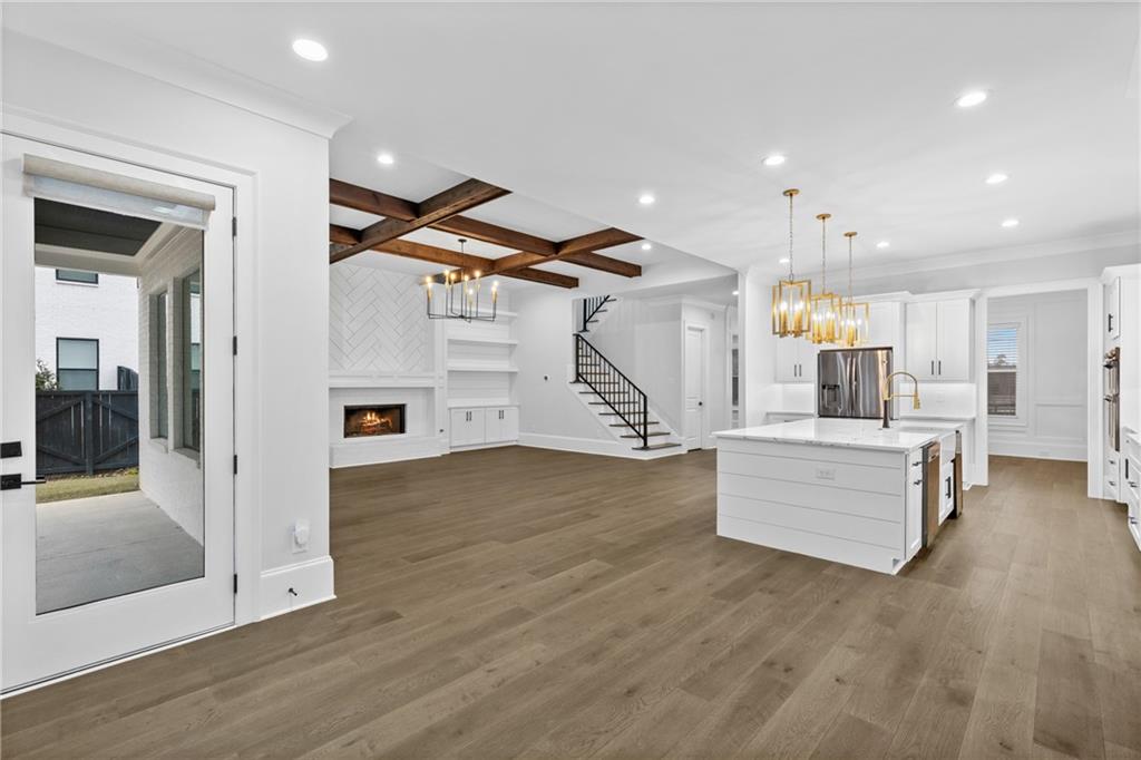 2381 Jones Phillips Road Dacula, GA 30019 - Photo 14 of 57 a view of kitchen with cabinets and wooden floor