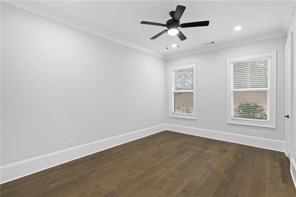 2381 Jones Phillips Road Dacula, GA 30019 - Photo 22 of 57 an empty room with a window and a fan