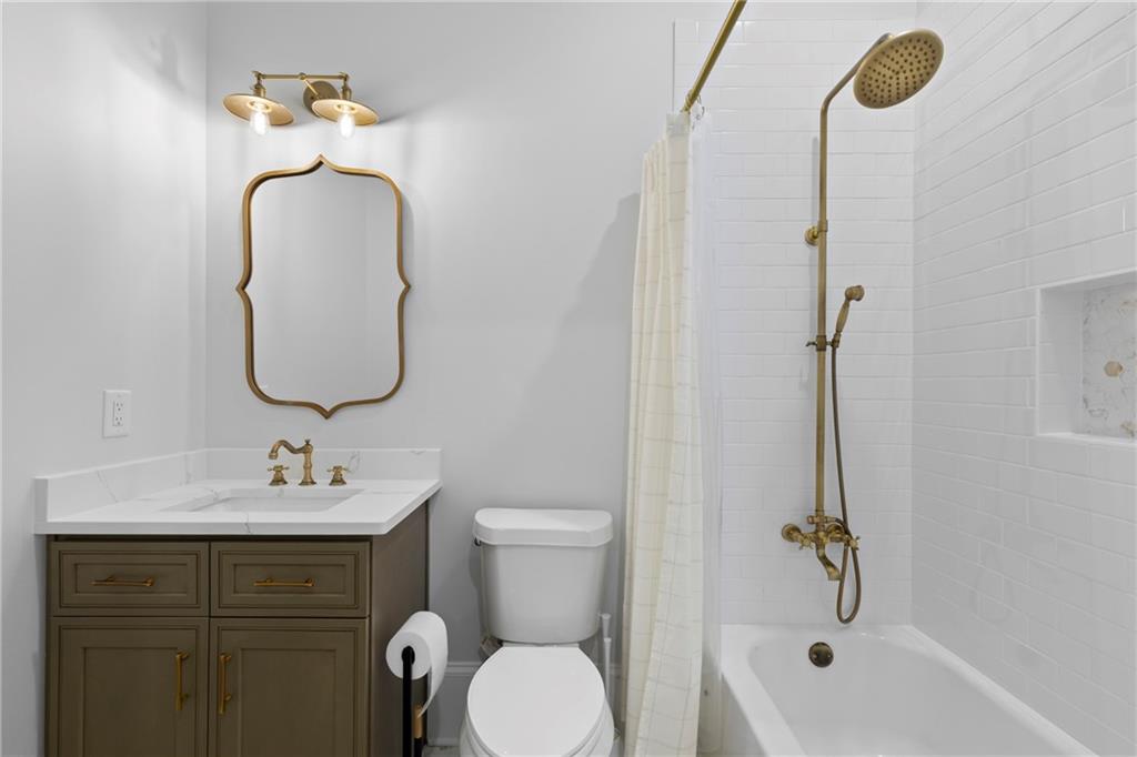 2381 Jones Phillips Road Dacula, GA 30019 - Photo 24 of 57 a bathroom with a sink vanity mirror and toilet