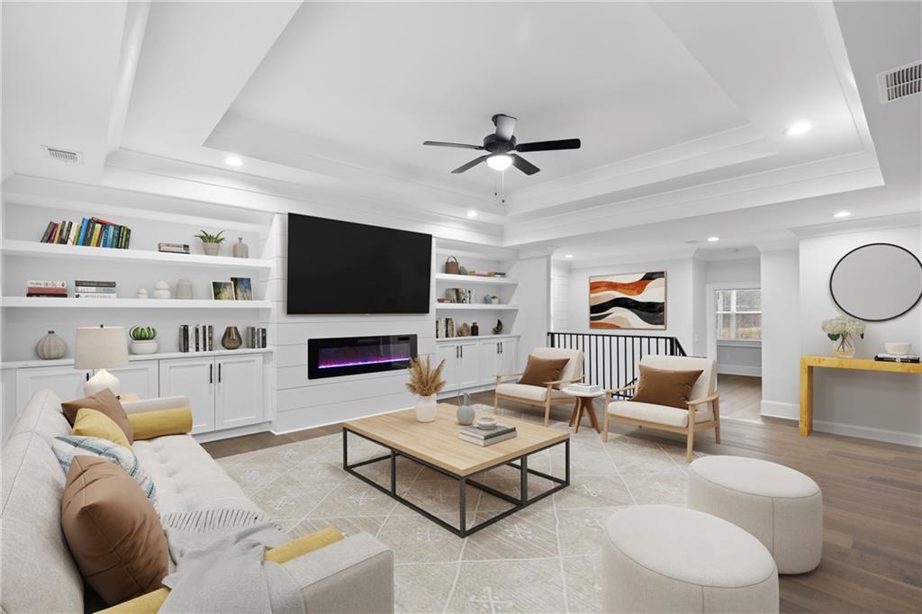 2381 Jones Phillips Road Dacula, GA 30019 - Photo 26 of 57 a living room with furniture and a flat screen tv