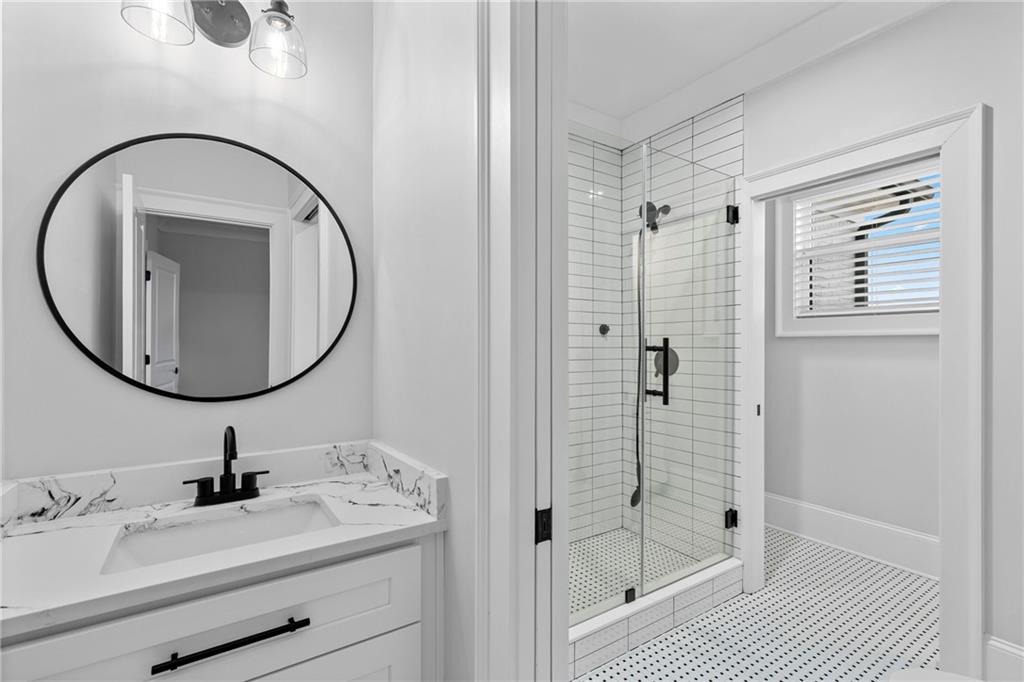 2381 Jones Phillips Road Dacula, GA 30019 - Photo 33 of 57 a bathroom with a sink a shower and a mirror