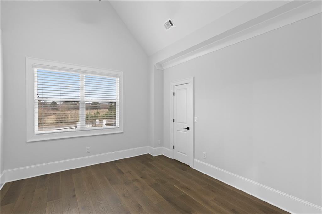 2381 Jones Phillips Road Dacula, GA 30019 - Photo 34 of 57 an empty room with wooden floor and a window