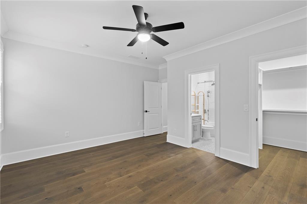 2381 Jones Phillips Road Dacula, GA 30019 - Photo 37 of 57 a view of empty room with wooden floor and ceiling fan