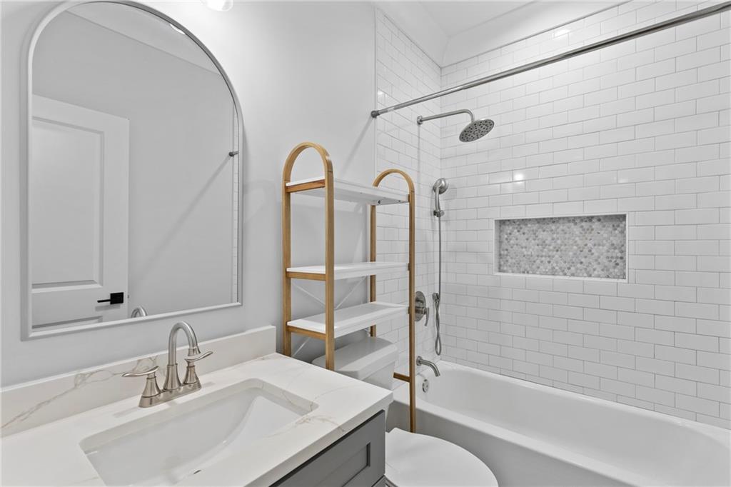 2381 Jones Phillips Road Dacula, GA 30019 - Photo 38 of 57 a bathroom with a granite countertop sink toilet and shower