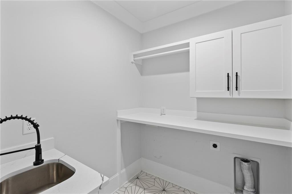 2381 Jones Phillips Road Dacula, GA 30019 - Photo 39 of 57 a kitchen with a sink and cabinets