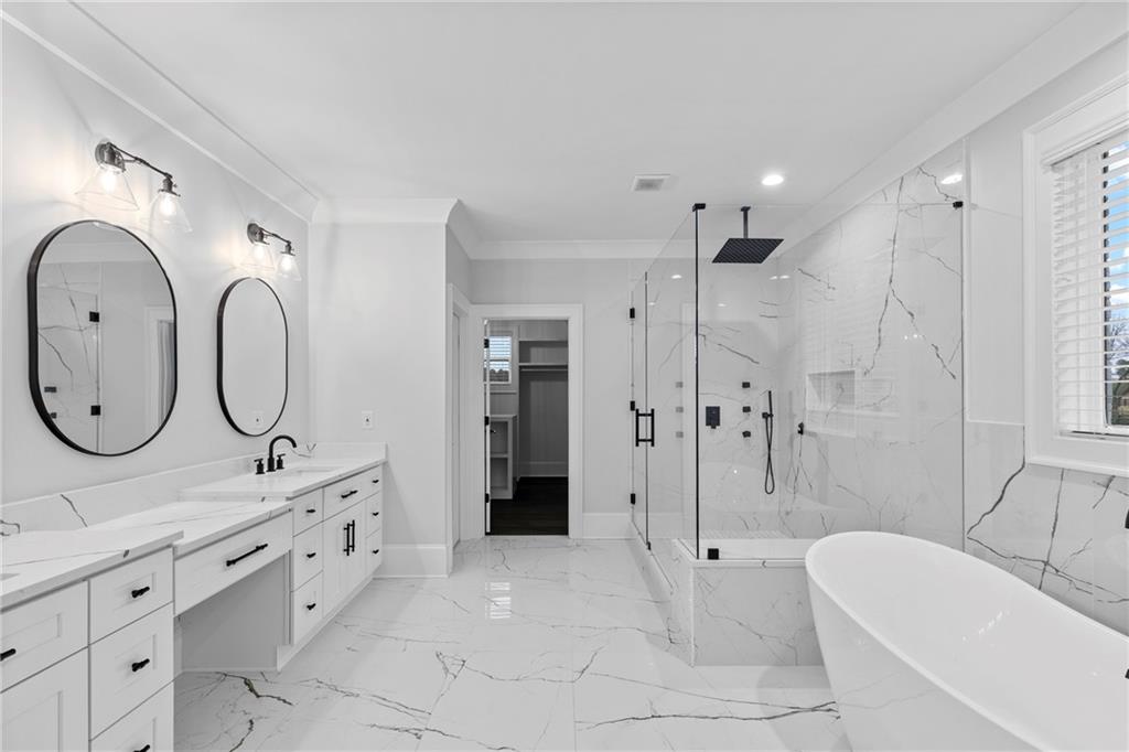2381 Jones Phillips Road Dacula, GA 30019 - Photo 43 of 57 a spacious bathroom with a double vanity sink mirror and shower