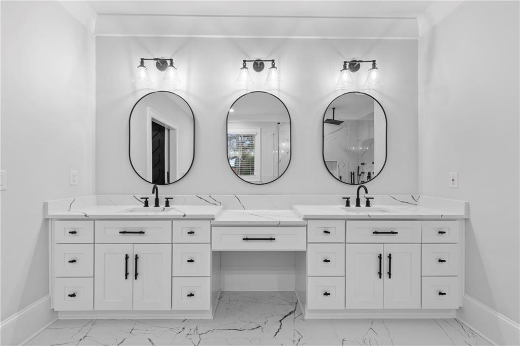 2381 Jones Phillips Road Dacula, GA 30019 - Photo 44 of 57 a bathroom with double vanity white cabinets and a mirror