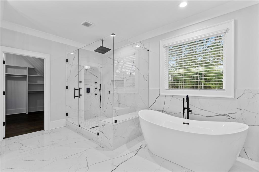 2381 Jones Phillips Road Dacula, GA 30019 - Photo 45 of 57 a bathroom with a bathtub and a shower