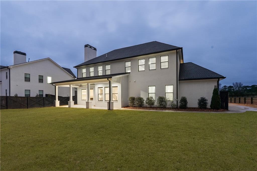 2381 Jones Phillips Road Dacula, GA 30019 - Photo 52 of 57 a large building with a big yard and large trees