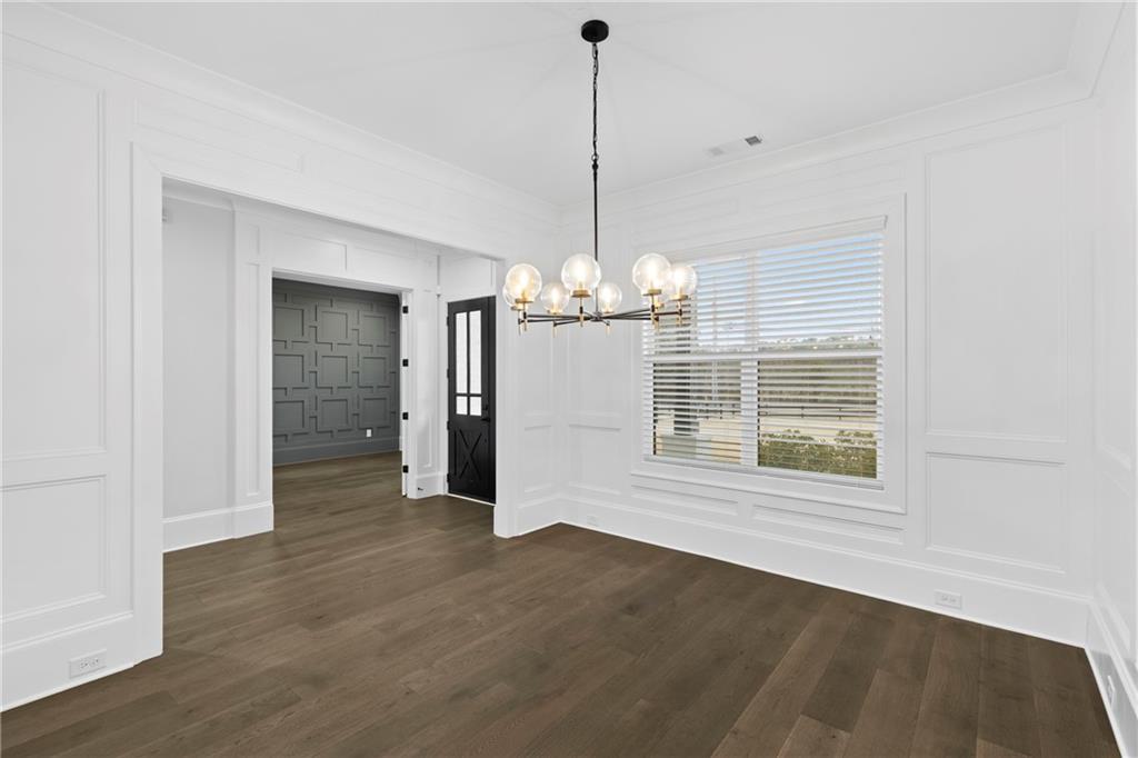 2381 Jones Phillips Road Dacula, GA 30019 - Photo 10 of 57 a view of a room with wooden floor chandelier and windows